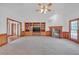 Bright living room with a fireplace and built-in shelving offers a cozy and inviting atmosphere at 3140 Thoreau Ct, Loganville, GA 30052