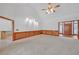 Open living room with neutral carpet, decorative lighting, and doorway access at 3140 Thoreau Ct, Loganville, GA 30052