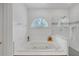 A main bathroom with a glass shower, jacuzzi tub, and large window at 3140 Thoreau Ct, Loganville, GA 30052