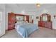 Spacious main bedroom with a large bed, wooden furniture, and a tray ceiling at 3140 Thoreau Ct, Loganville, GA 30052