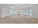 A spacious main bedroom with carpet, many windows, and lots of natural light at 3140 Thoreau Ct, Loganville, GA 30052