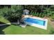 Relaxing in-ground pool area with a patio and lush landscaping, perfect for outdoor entertaining at 3140 Thoreau Ct, Loganville, GA 30052