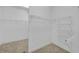 A walk-in closet with white wire shelving and neutral carpet at 3140 Thoreau Ct, Loganville, GA 30052