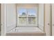 Bright bathroom showcasing a standalone tub with a large window, perfect for relaxation and natural light at 3834 Chamblee Dunwoody Rd, Atlanta, GA 30341