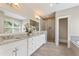 Bright bathroom with white vanity, granite counters, tiled walk-in shower and soaking tub at 3834 Chamblee Dunwoody Rd, Atlanta, GA 30341
