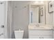 Bathroom features a modern sink, toilet, and a shower behind glass doors with gray tiling at 3834 Chamblee Dunwoody Rd, Atlanta, GA 30341