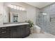 Modern bathroom boasts a vanity with a large mirror, stylish lighting, and a sleek glass-enclosed shower at 3834 Chamblee Dunwoody Rd, Atlanta, GA 30341