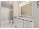 Bathroom featuring granite counters, white cabinets, tub-shower combo with tile surround at 3834 Chamblee Dunwoody Rd, Atlanta, GA 30341