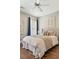 Cozy bedroom featuring hardwood floors, a ceiling fan, and a well-lit window with curtains at 3834 Chamblee Dunwoody Rd, Atlanta, GA 30341