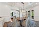 Elegant dining room with coffered ceiling, modern chandelier, and access to a living room at 3834 Chamblee Dunwoody Rd, Atlanta, GA 30341