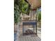 Outdoor stone fireplace with a mounted television, perfect for relaxation on the covered deck at 3834 Chamblee Dunwoody Rd, Atlanta, GA 30341