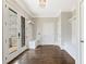Welcoming foyer with hardwood floors, bench seating and convenient coat racks at 3834 Chamblee Dunwoody Rd, Atlanta, GA 30341