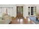 The foyer features double glass doors, hardwood floors, and access to other rooms at 3834 Chamblee Dunwoody Rd, Atlanta, GA 30341
