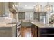 The kitchen features stainless steel appliances, grey cabinets, an island, and modern lighting at 3834 Chamblee Dunwoody Rd, Atlanta, GA 30341