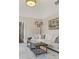 Living room with high ceilings, decorative light fixture and wall art at 3834 Chamblee Dunwoody Rd, Atlanta, GA 30341