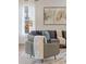 Living room features a cozy chair, plush throw pillows and blankets, and a modern painting at 3834 Chamblee Dunwoody Rd, Atlanta, GA 30341