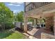Outdoor covered living area with stone columns, fireplace, tv and dual hot tubs at 3834 Chamblee Dunwoody Rd, Atlanta, GA 30341