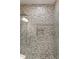 Custom shower with decorative horizontal tile work and mosaic tile floor at 3834 Chamblee Dunwoody Rd, Atlanta, GA 30341