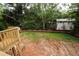 Expansive backyard with lush trees, home exterior, and wooden deck create a relaxing and beautiful outdoor space at 1115 Ralph Ne Rd, Atlanta, GA 30324