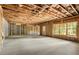 Unfinished basement provides a vast and customizable space with exposed beams and a window at 1115 Ralph Ne Rd, Atlanta, GA 30324