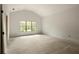 Spacious bedroom showcases light walls, vaulted ceiling and hardwood flooring, complemented by a large window view at 1115 Ralph Ne Rd, Atlanta, GA 30324