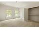 Light-filled bedroom with hardwood floors has an open closet, enhancing its inviting and spacious appeal at 1115 Ralph Ne Rd, Atlanta, GA 30324