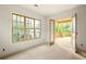 Sunny bedroom features large windows, light hardwood floors, and direct access to a private deck at 1115 Ralph Ne Rd, Atlanta, GA 30324