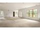 Spacious living room boasts light hardwood floors, neutral paint, and large windows for ample natural light at 1115 Ralph Ne Rd, Atlanta, GA 30324