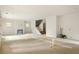 Large open-concept living room with light hardwood floors, a fireplace, and a staircase to the second floor at 1115 Ralph Ne Rd, Atlanta, GA 30324
