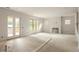 Large living area has light hardwood floors, big windows, and a glass door leading to a deck at 1115 Ralph Ne Rd, Atlanta, GA 30324