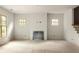 Open-concept living room features light hardwood floors, neutral paint, a fireplace, and large windows at 1115 Ralph Ne Rd, Atlanta, GA 30324