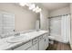 Bathroom featuring a double sink vanity with marble countertop and shower with tub at 228 Whitneys Way, Dallas, GA 30157