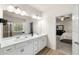 Bright bathroom featuring a double vanity, shower and view into the main bedroom at 228 Whitneys Way, Dallas, GA 30157