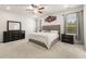 Main bedroom featuring a bed with a soft-hued comforter, dresser, and gray curtains at 228 Whitneys Way, Dallas, GA 30157