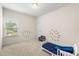 bedroom with carpet, decorated walls, and a bright bed with a star pattern at 228 Whitneys Way, Dallas, GA 30157