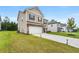 Side view of a two-story home, showcasing a well-manicured lawn and long driveway at 228 Whitneys Way, Dallas, GA 30157