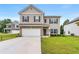 Charming two-story home featuring neutral siding, brick accents, a two-car garage, and a well-maintained lawn at 228 Whitneys Way, Dallas, GA 30157