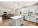 Open concept kitchen with a center island, stainless steel appliances, and a view into the dining and living areas at 228 Whitneys Way, Dallas, GA 30157