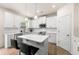 Modern kitchen featuring white cabinets, quartz countertops, stainless steel appliances, and an island with barstools at 228 Whitneys Way, Dallas, GA 30157