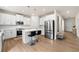 Bright kitchen with white cabinets, stainless steel appliances, and a central island with bar seating at 228 Whitneys Way, Dallas, GA 30157