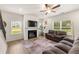 Cozy living room featuring a fireplace, large windows, hardwood floors, and comfortable seating at 228 Whitneys Way, Dallas, GA 30157