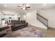 Open-concept living space with hardwood floors, connecting the kitchen, living room, and staircase at 228 Whitneys Way, Dallas, GA 30157