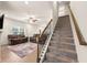 Carpeted staircase with wooden banister that leads to the upper level at 228 Whitneys Way, Dallas, GA 30157
