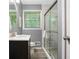 Updated bathroom features a glass shower, modern vanity, and neutral tones at 3510 Dunn Se St, Smyrna, GA 30080