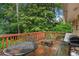 An outdoor deck provides a delightful entertainment space with a table, chairs, and a grill at 3510 Dunn Se St, Smyrna, GA 30080