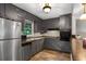 Efficient kitchen with stainless steel appliances and dark cabinets at 3510 Dunn Se St, Smyrna, GA 30080