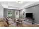 Inviting living room with neutral colors, a large couch, and a mounted television at 3510 Dunn Se St, Smyrna, GA 30080