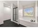 Modern bathroom with a soaking tub, glass enclosed shower, and black tiled floors at 3524 Preserve Run Trl, Loganville, GA 30052