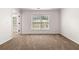 A secondary bedroom with a window, neutral carpet and white trim at 3524 Preserve Run Trl, Loganville, GA 30052