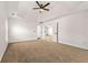 A bright bedroom with a tray ceiling, fan, neutral carpet, and white trim at 3524 Preserve Run Trl, Loganville, GA 30052